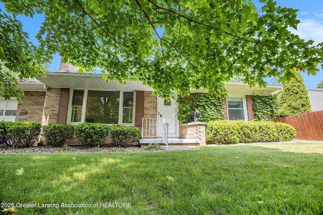 2782 Roseland Ave, East Lansing, MI 48823 - obstructed view of property featuring brick siding and a chimney
