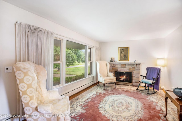 2782 Roseland Ave, East Lansing, MI 48823 - living area with a baseboard heating unit, wood finished floors, and a fireplace