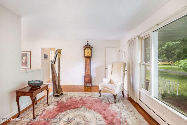 2782 Roseland Ave, East Lansing, MI 48823 - living area featuring a baseboard heating unit and wood finished floors