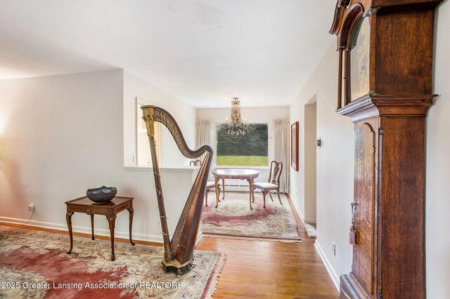2782 Roseland Ave, East Lansing, MI 48823 - hallway with a chandelier and wood finished floors