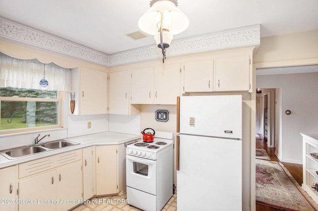 2782 Roseland Ave, East Lansing, MI 48823 - kitchen with white appliances, light countertops, and cream cabinetry