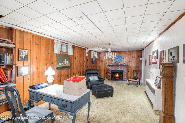 2782 Roseland Ave, East Lansing, MI 48823 - living room with carpet, wooden walls, radiator heating unit, and a fireplace
