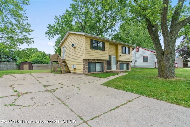 4733 S Pennsylvania Ave, Lansing, MI 48910 - bi-level home with a shed, stairway, brick siding, and driveway