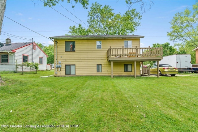 4733 S Pennsylvania Ave, Lansing, MI 48910 - back of house featuring a yard and a wooden deck