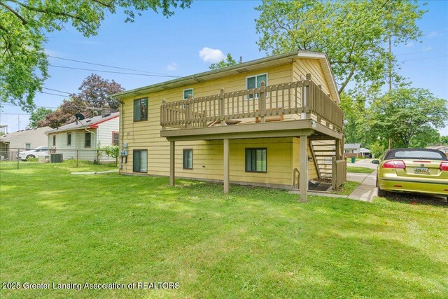 4733 S Pennsylvania Ave, Lansing, MI 48910 - rear view of house with a wooden deck and stairway