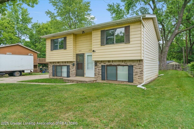 4733 S Pennsylvania Ave, Lansing, MI 48910 - bi-level home featuring driveway, brick siding, and a garage