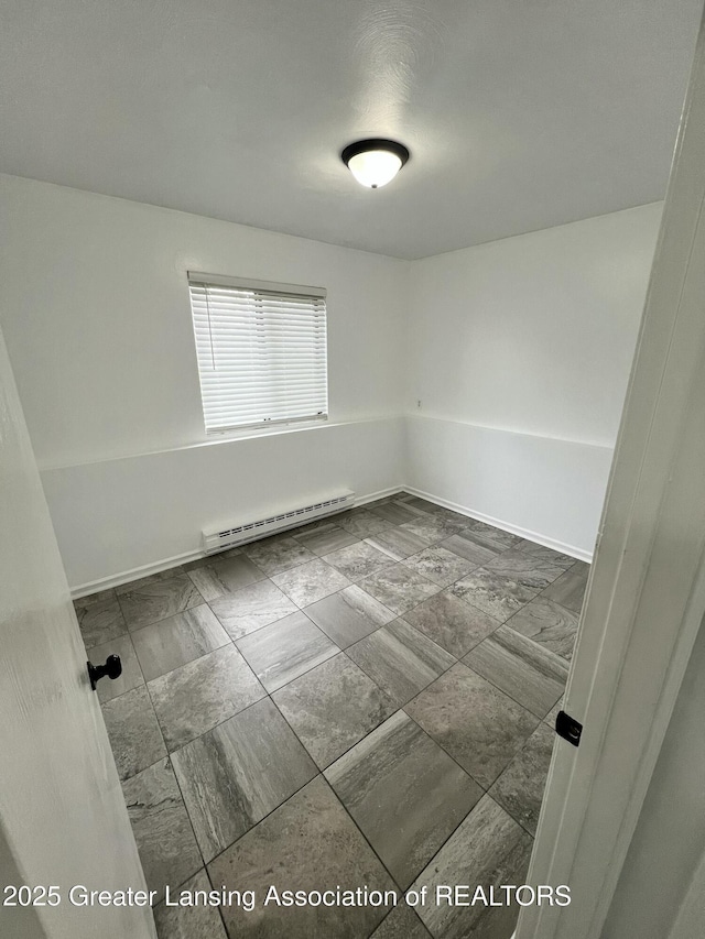 4733 S Pennsylvania Ave, Lansing, MI 48910 - empty room featuring a baseboard heating unit and baseboards