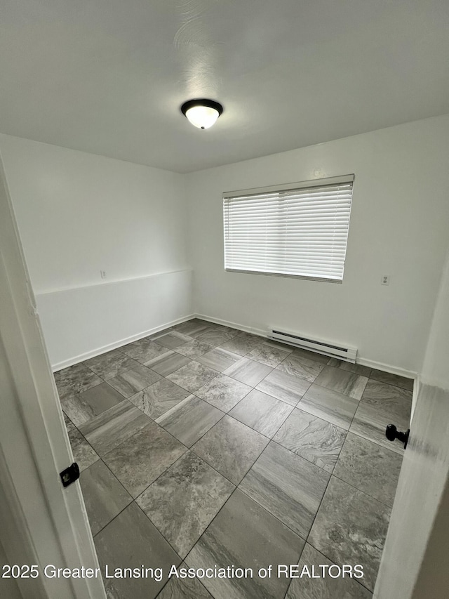 4733 S Pennsylvania Ave, Lansing, MI 48910 - unfurnished room featuring a baseboard radiator and dark marble finish flooring