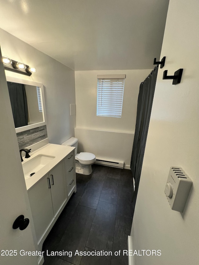 4733 S Pennsylvania Ave, Lansing, MI 48910 - full bath with a baseboard heating unit, vanity, decorative backsplash, and a shower with curtain
