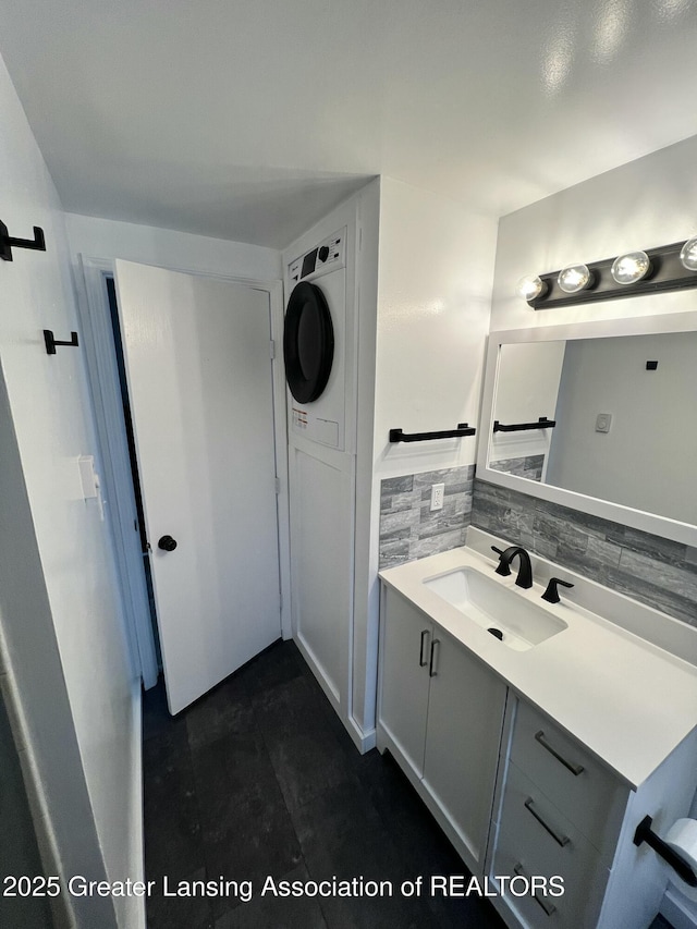 4733 S Pennsylvania Ave, Lansing, MI 48910 - bathroom featuring stacked washer / drying machine and vanity