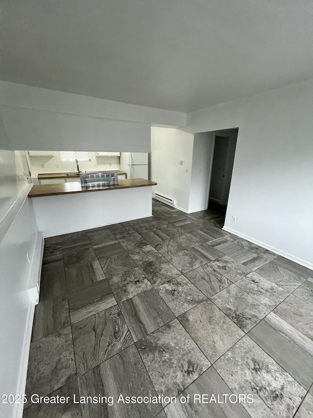 4733 S Pennsylvania Ave, Lansing, MI 48910 - spare room featuring baseboards and a sink
