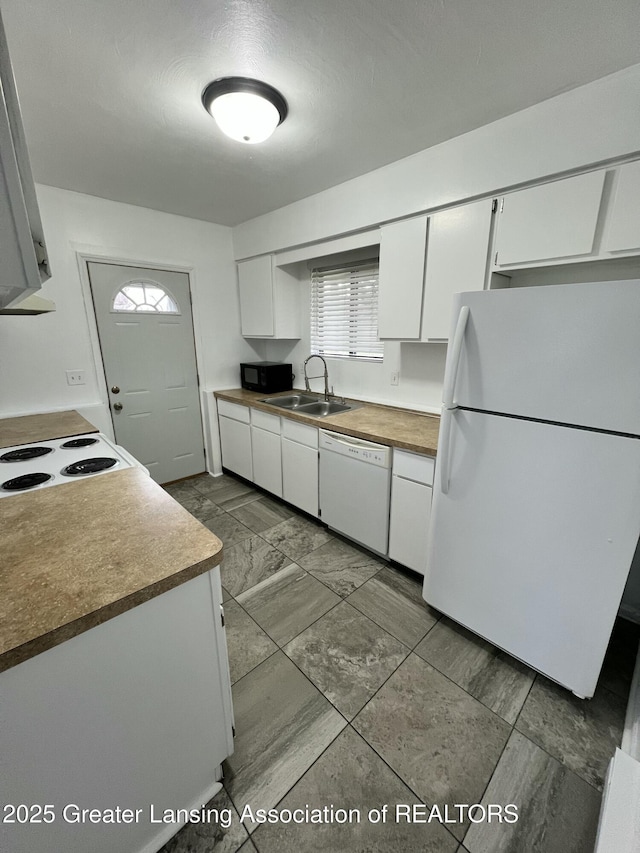 4733 S Pennsylvania Ave, Lansing, MI 48910 - kitchen with white appliances, white cabinets, ventilation hood, and dark marble finish flooring