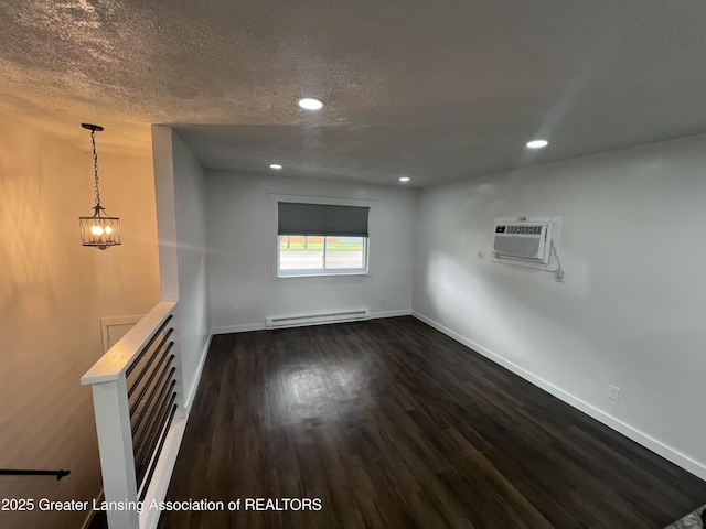 4733 S Pennsylvania Ave, Lansing, MI 48910 - spare room featuring baseboard heating, a wall mounted air conditioner, dark wood-type flooring, a textured ceiling, and recessed lighting