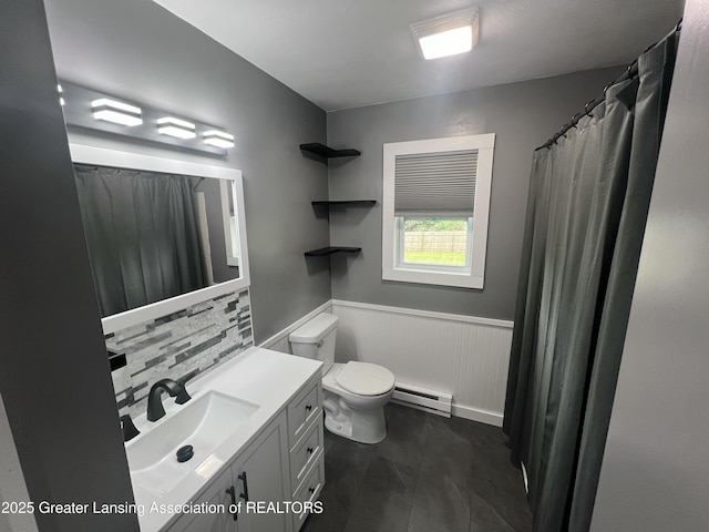 4733 S Pennsylvania Ave, Lansing, MI 48910 - full bathroom featuring a baseboard heating unit, wainscoting, vanity, and decorative backsplash