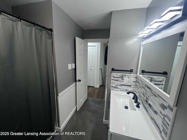 4733 S Pennsylvania Ave, Lansing, MI 48910 - bathroom featuring vanity and decorative backsplash