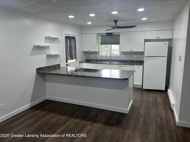 4733 S Pennsylvania Ave, Lansing, MI 48910 - kitchen with white appliances, a peninsula, open shelves, dark wood-style flooring, and ceiling fan
