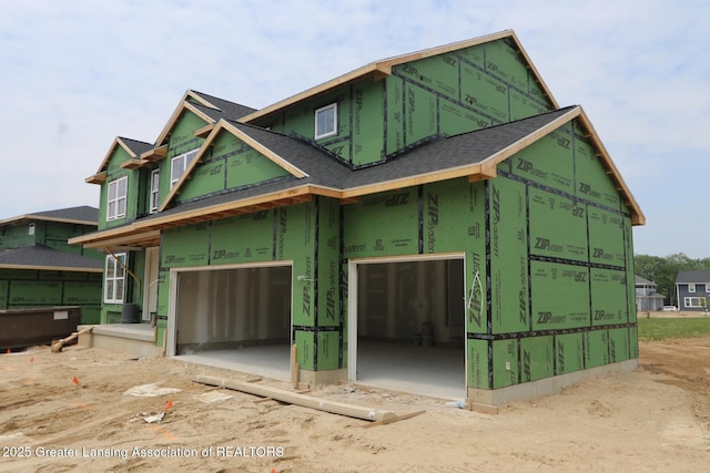 612 Titanium Trl, Haslett, MI 48840 - view of front of home with an attached garage and roof with shingles