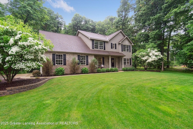 3901 W Howe Rd, Dewitt, MI 48820 - view of front of house with a front yard, brick siding, and a shingled roof