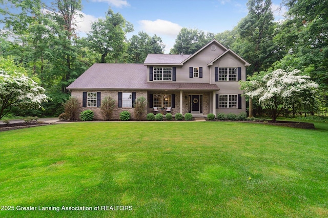3901 W Howe Rd, Dewitt, MI 48820 - traditional-style home with a porch, a front lawn, and brick siding