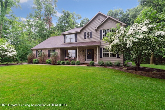 3901 W Howe Rd, Dewitt, MI 48820 - traditional-style house featuring a porch, a front lawn, and brick siding