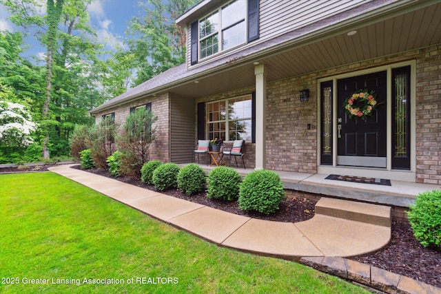 3901 W Howe Rd, Dewitt, MI 48820 - entrance to property featuring covered porch, brick siding, and a lawn