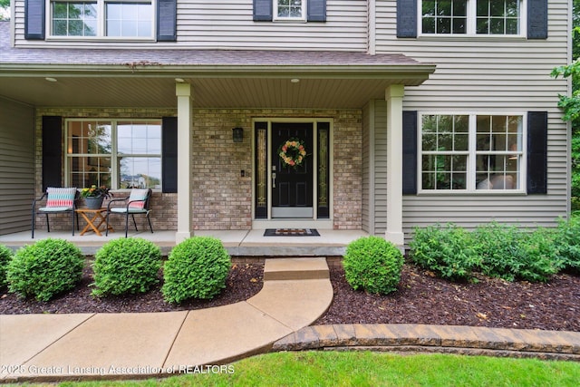 3901 W Howe Rd, Dewitt, MI 48820 - view of exterior entry featuring covered porch and brick siding