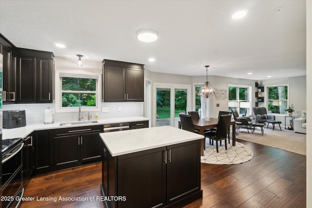 3901 W Howe Rd, Dewitt, MI 48820 - kitchen with double oven range, light countertops, open floor plan, decorative backsplash, and recessed lighting