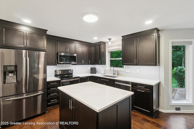 3901 W Howe Rd, Dewitt, MI 48820 - kitchen with stainless steel appliances, tasteful backsplash, light countertops, dark wood-style floors, and recessed lighting