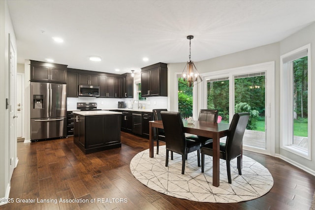 3901 W Howe Rd, Dewitt, MI 48820 - dining area with a chandelier, dark wood-style floors, and recessed lighting