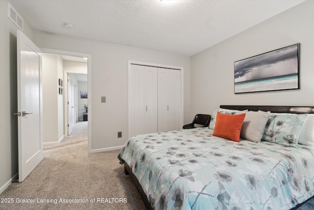3901 W Howe Rd, Dewitt, MI 48820 - bedroom featuring light colored carpet, a closet, and a textured ceiling