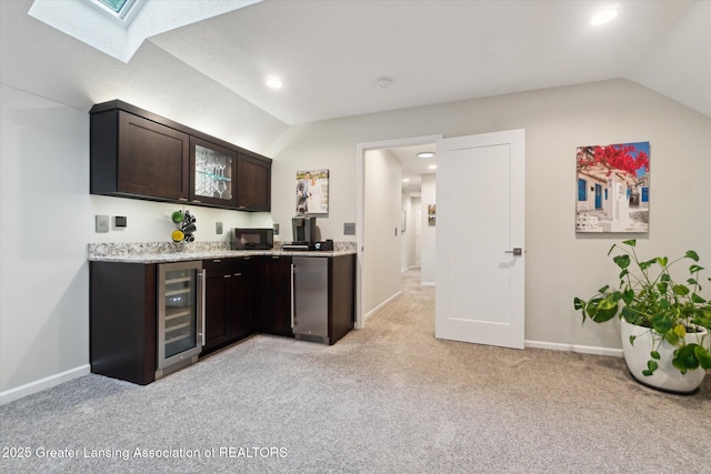 3901 W Howe Rd, Dewitt, MI 48820 - indoor bar with beverage cooler, lofted ceiling, light carpet, a skylight, and recessed lighting