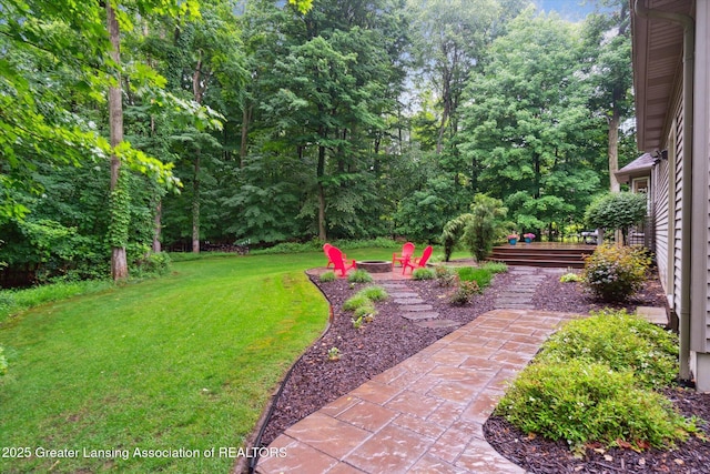 3901 W Howe Rd, Dewitt, MI 48820 - view of grassy yard featuring a fire pit