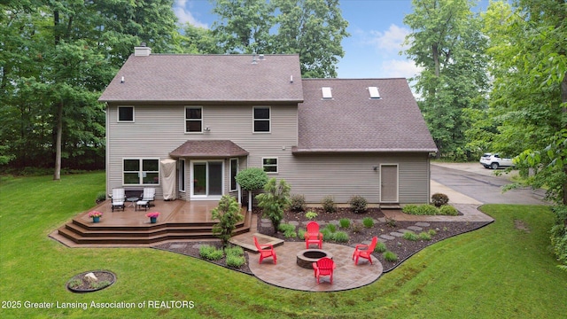 3901 W Howe Rd, Dewitt, MI 48820 - back of property featuring a deck, an outdoor fire pit, roof with shingles, a lawn, and a chimney