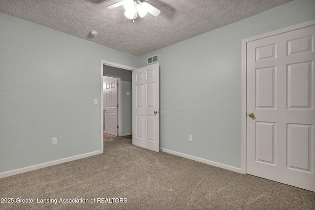 1015 Lake Lansing Rd, Lansing, MI 48906 - unfurnished bedroom featuring carpet floors, a textured ceiling, and a ceiling fan