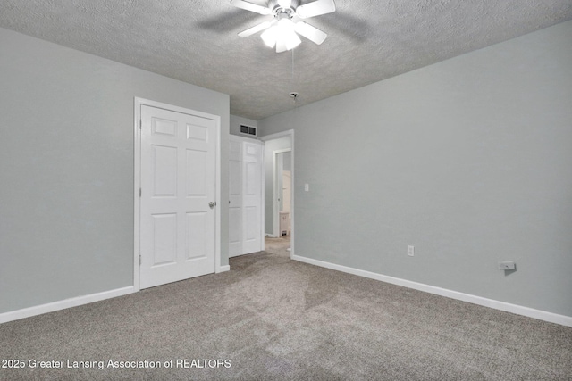 1015 Lake Lansing Rd, Lansing, MI 48906 - unfurnished bedroom with carpet floors, a textured ceiling, and ceiling fan