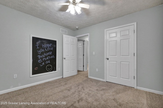1015 Lake Lansing Rd, Lansing, MI 48906 - unfurnished bedroom featuring a textured ceiling, carpet, and a ceiling fan