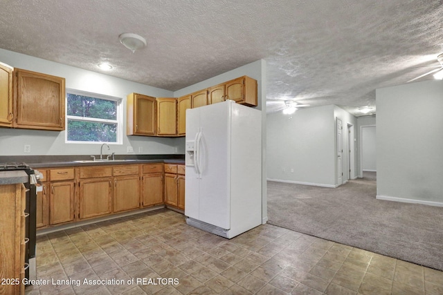1015 Lake Lansing Rd, Lansing, MI 48906 - kitchen with white fridge with ice dispenser, a ceiling fan, a textured ceiling, stainless steel gas stove, and light carpet