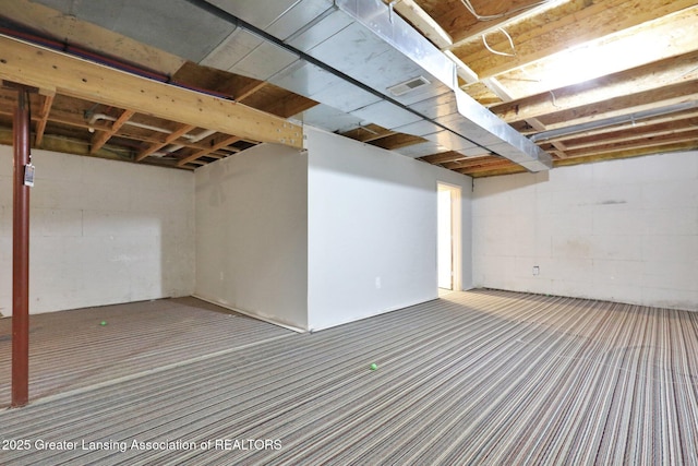 1015 Lake Lansing Rd, Lansing, MI 48906 - unfinished below grade area featuring carpet and concrete block wall
