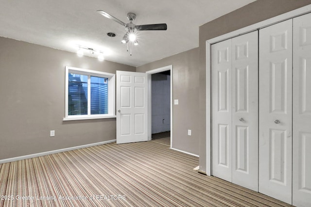 1015 Lake Lansing Rd, Lansing, MI 48906 - unfurnished bedroom with carpet flooring, a closet, and a ceiling fan