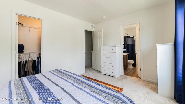 1118 River Oaks Dr, Dewitt, MI 48820 - bedroom with light carpet, a closet, ensuite bathroom, and a walk in closet