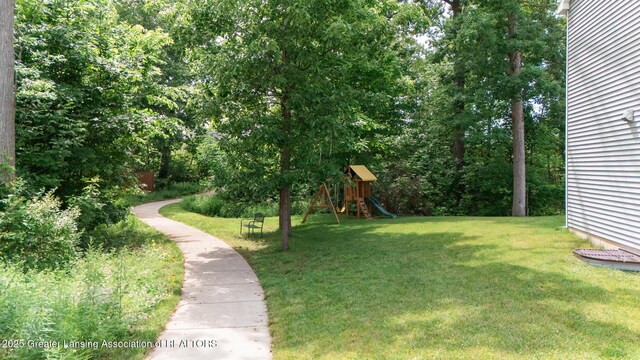 1118 River Oaks Dr, Dewitt, MI 48820 - view of grassy yard with a playground