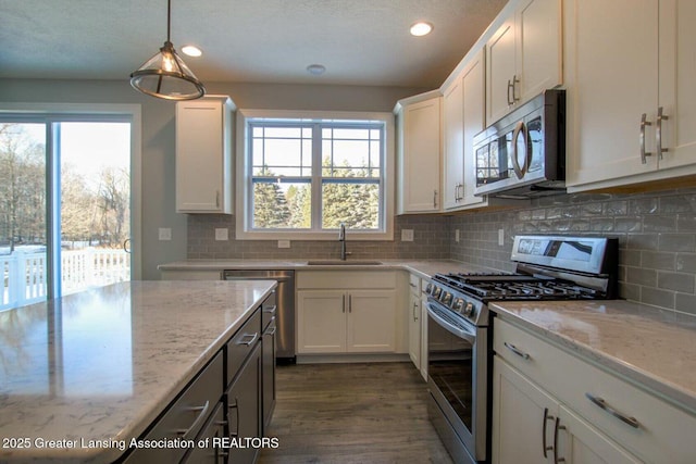 616 Magenta Ct, Haslett, MI 48840 - kitchen with appliances with stainless steel finishes, healthy amount of natural light, white cabinets, and recessed lighting
