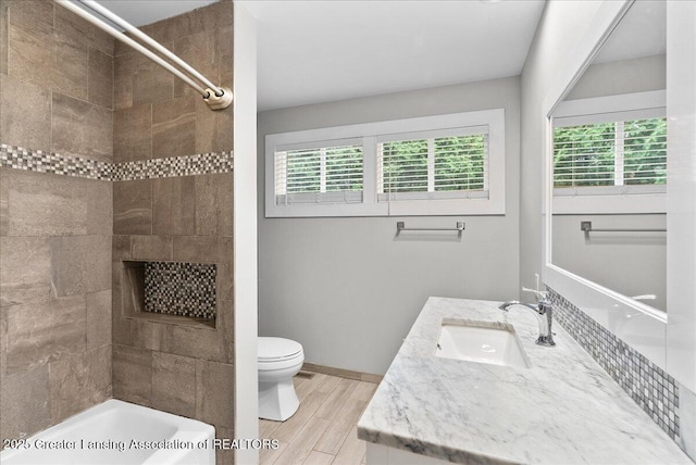 17 Charles E Pl, Battle Creek, MI 49015 - full bathroom featuring plenty of natural light, vanity, wood finished floors, and shower / tub combination