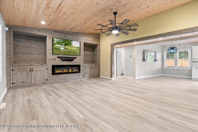 17 Charles E Pl, Battle Creek, MI 49015 - unfurnished living room with wooden ceiling, a large fireplace, a ceiling fan, wooden walls, and wood finished floors