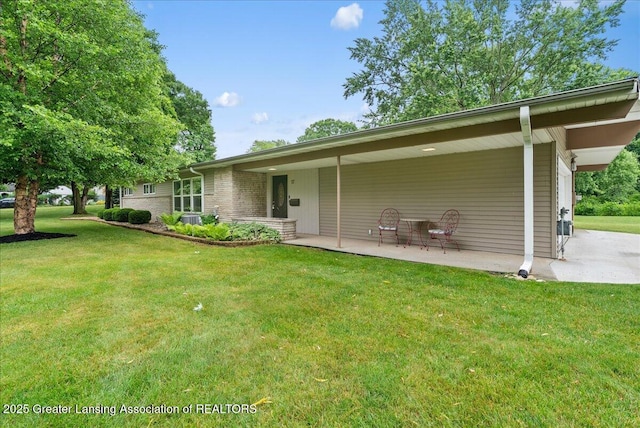 17 Charles E Pl, Battle Creek, MI 49015 - rear view of house featuring a lawn