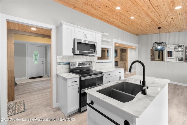 17 Charles E Pl, Battle Creek, MI 49015 - kitchen with stainless steel appliances, wood ceiling, white cabinetry, light stone counters, and light wood-style floors