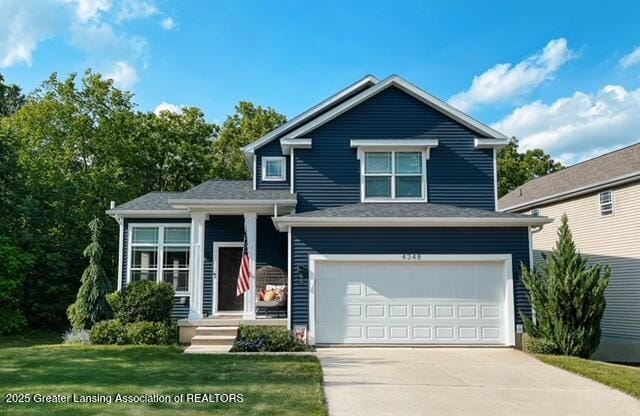 4348 Norway St, Holt, MI 48842 - view of front of house featuring driveway, an attached garage, and a front lawn