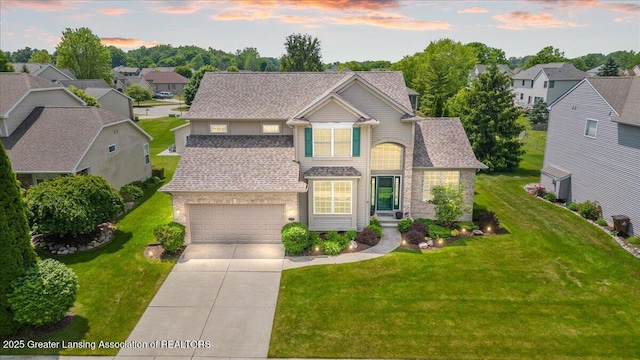 10889 Pointe W Blvd, Grand Ledge, MI 48837 - view of front of home featuring concrete driveway, a front yard, a shingled roof, and a residential view