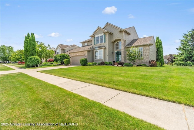 10889 Pointe W Blvd, Grand Ledge, MI 48837 - traditional home featuring concrete driveway, a front lawn, and a garage