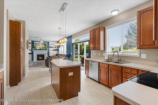 10889 Pointe W Blvd, Grand Ledge, MI 48837 - kitchen featuring dishwasher, brown cabinets, a lit fireplace, and a textured ceiling